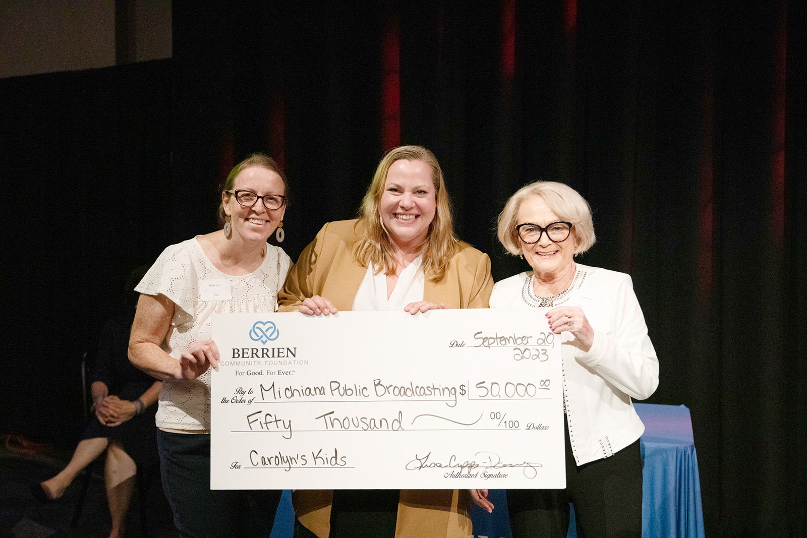Carolyn Hanson (right) creator of Carolyn’s Kids grant, presents a $50,000 check to Michiana Public Broadcasting’s Heather Frey (left) and Amanda Miller Kelley (center) September 20 at Berrien Community Foundation's Annual Meeting & Celebration. was selected as a Michiana Public Broadcasting Carolyn’s Kids grant winner.
