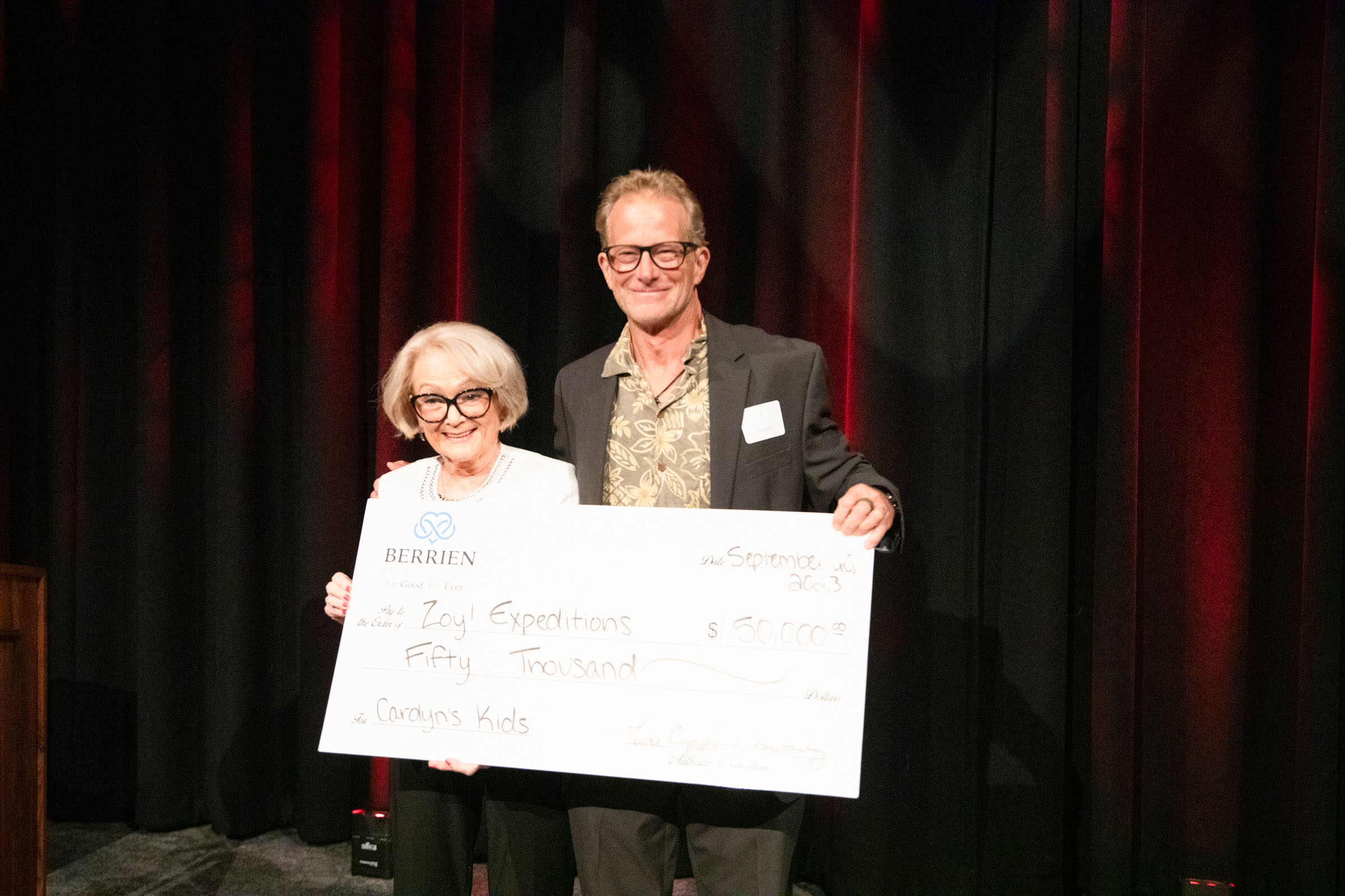 Carolyn Hanson (left) creator of Carolyn’s Kids grant, presents a $50,000 check to ZoY! Expeditions founder Al Mussman (right) September 20 at Berrien Community Foundation's Annual Meeting & Celebration. ZoY! Expeditions was selected as a $50,000 Carolyn’s Kids winner.
