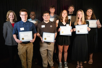 Group of teenagers, each holding certificates. 