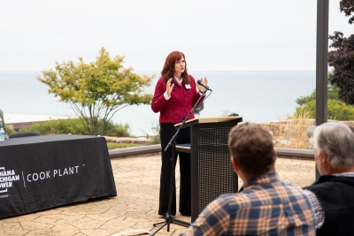 woman standing behind podium.