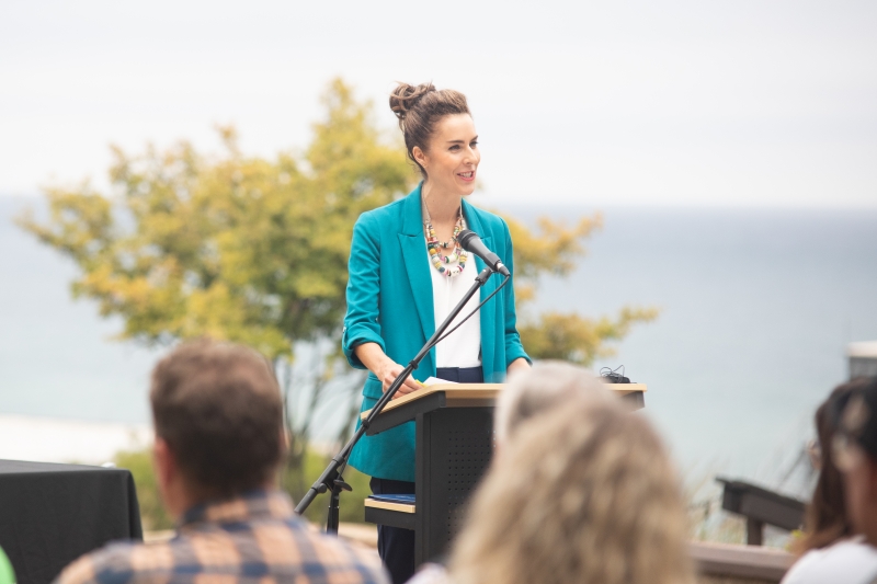 Woman speaking at podium.