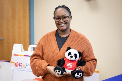 photo of a woman holding teddy bear. 