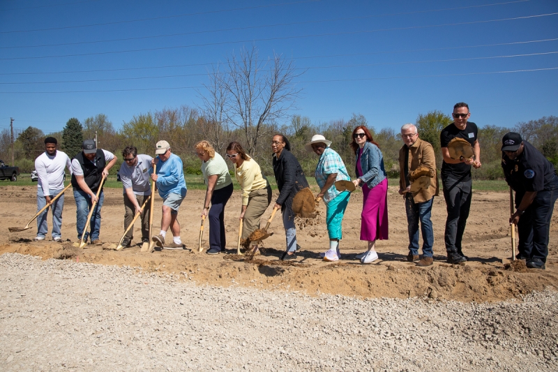 a group throws dirt in the air to "break ground" at Euclid Avenue Park in Benton Heights.