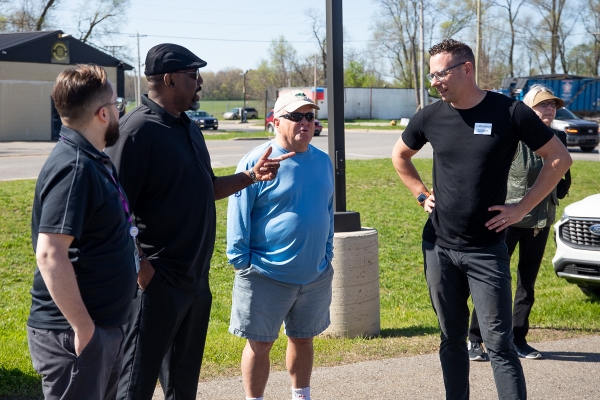 group of men talking at the ground breaking.