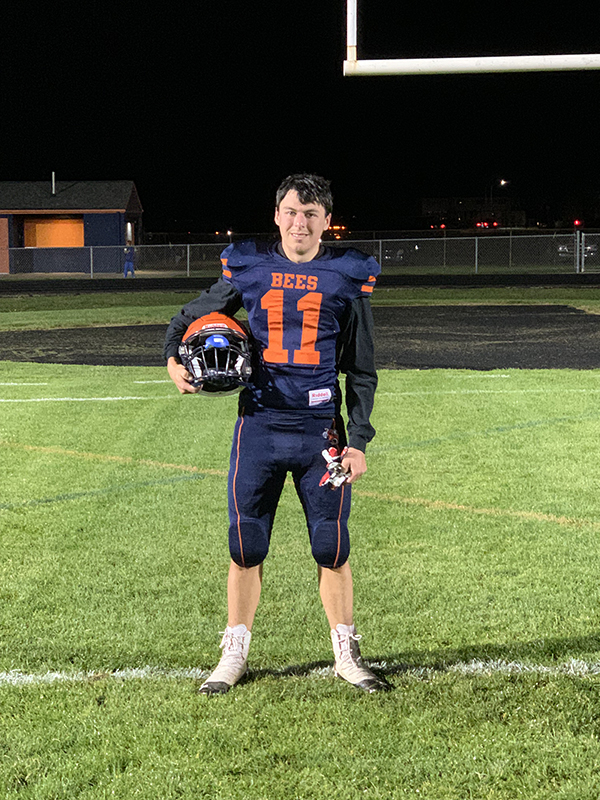 Zac in a Bridgman football uniform standing in the end zone.