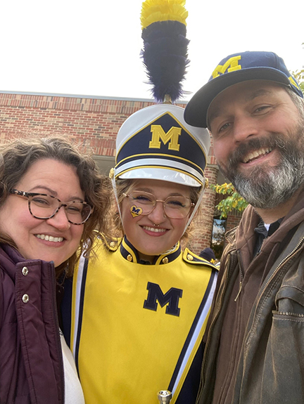 Three people smiling.