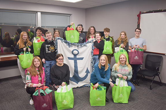 TEAM members showing the holiday care packages. 