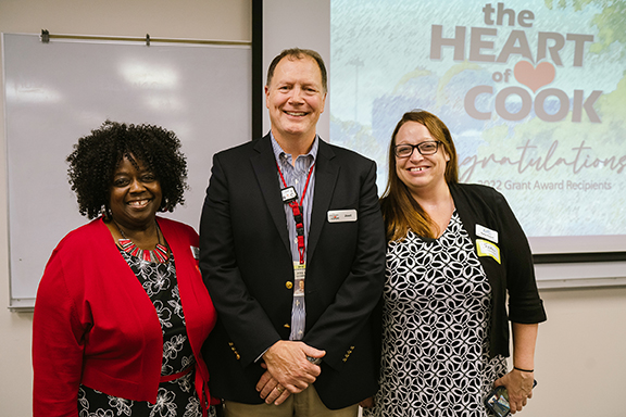 Three people standing together at Heart of Cook reception.