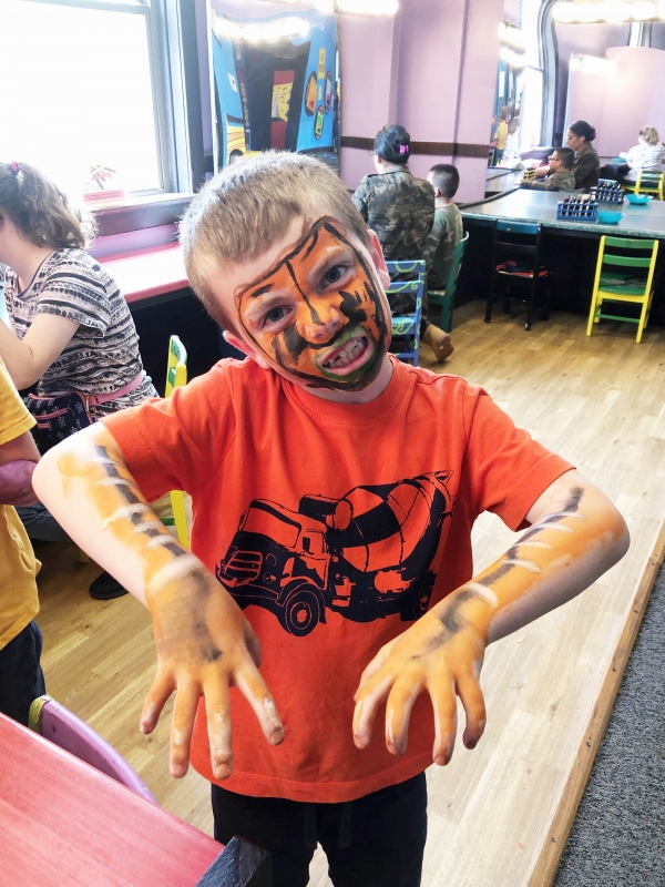 Andrew Layman as a child making a scary growling face