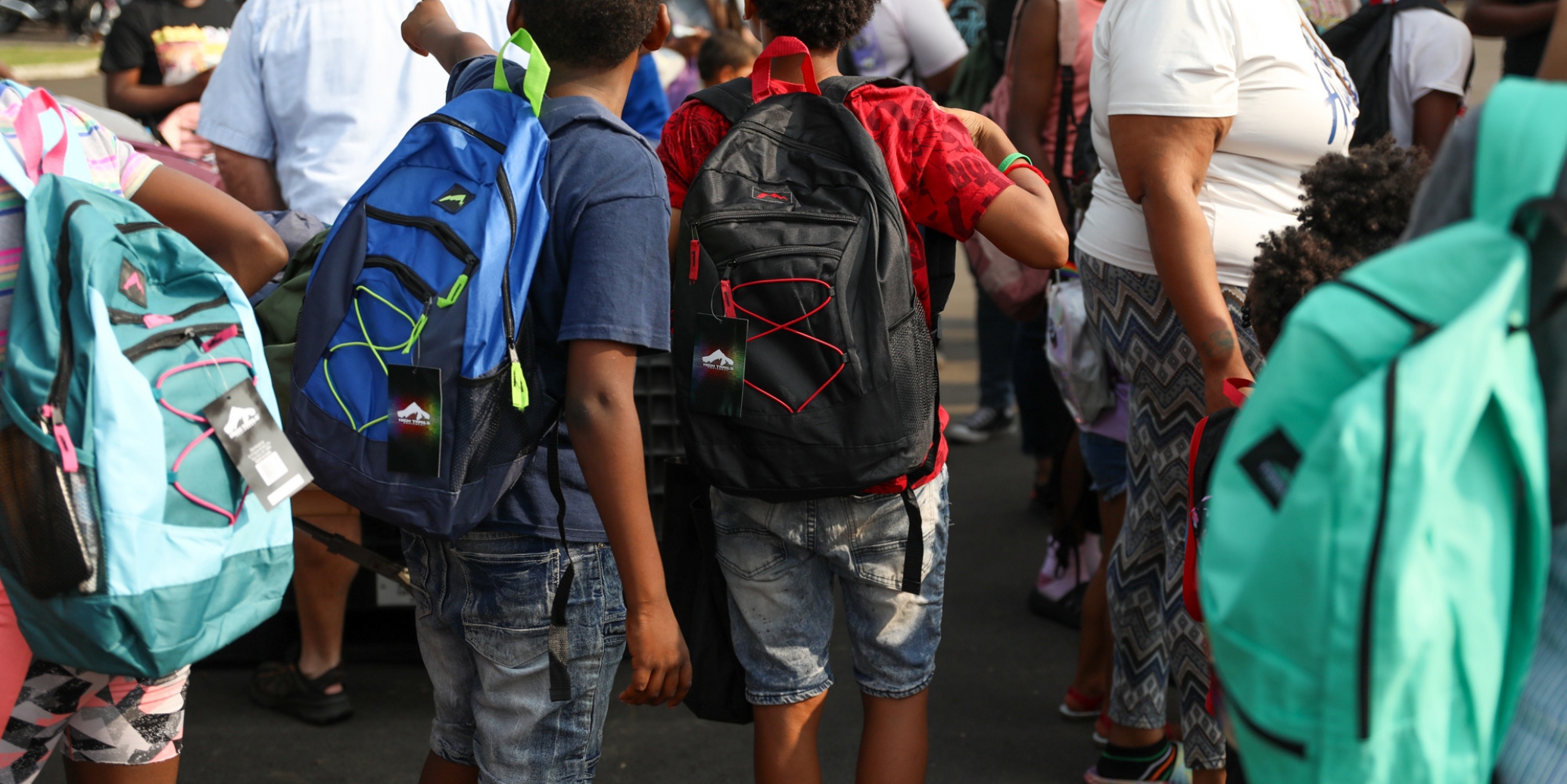 Photo of children wearing backpacks.