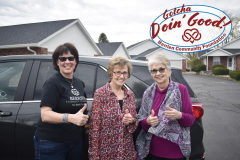 Three women giving a thumbs up.