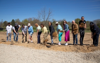 a group throws dirt in the air to "break ground" at Euclid Avenue Park in Benton Heights.