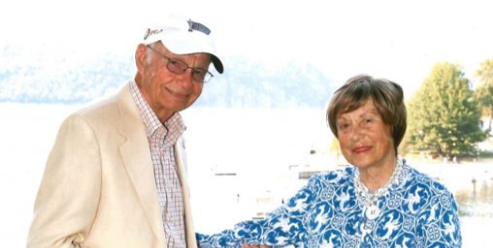portrait of Steve Upton and Elizabeth Upton with a Golden Retriever between them.